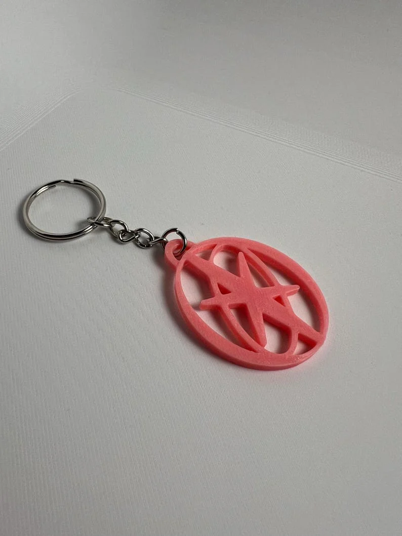 Katseye Inspired Logo EYEKONS Glow-in-the-Dark Keychain - KATSEYE MERCH​