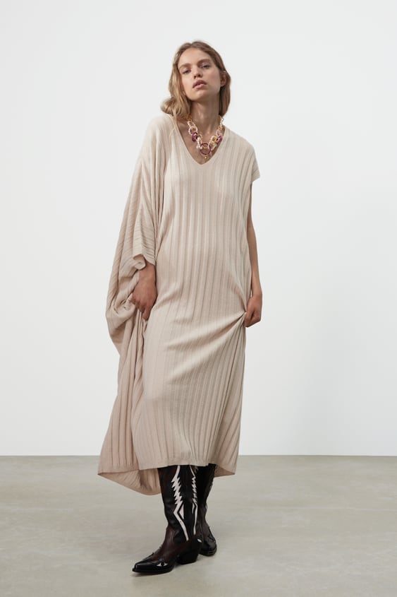 ASYMMETRIC SLEEVE KNIT CAPE